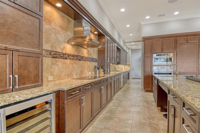 7638 Windy Hill Cv, Bradenton, FL 34202 - kitchen with beverage cooler, exhaust hood, tasteful backsplash, crown molding, and light stone counters