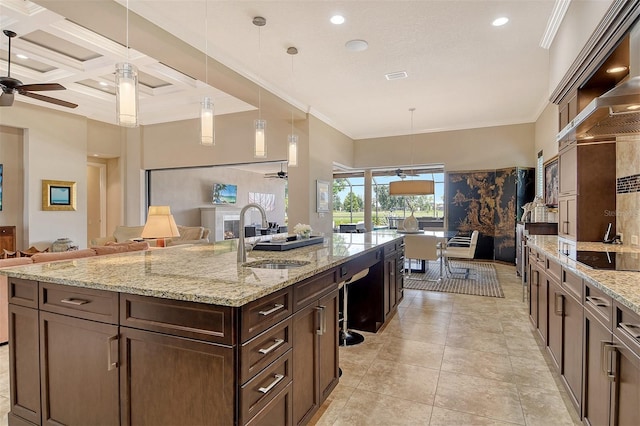 7638 Windy Hill Cv, Bradenton, FL 34202 - kitchen with a ceiling fan, open floor plan, a spacious island, black electric cooktop, and pendant lighting