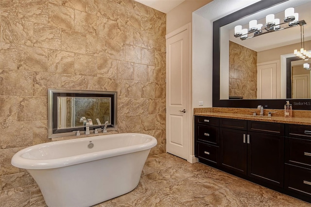 7638 Windy Hill Cv, Bradenton, FL 34202 - full bath with a soaking tub, vanity, and tile walls