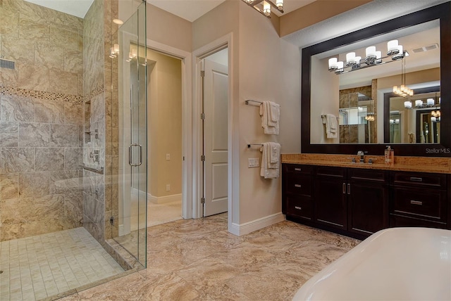 7638 Windy Hill Cv, Bradenton, FL 34202 - bathroom with a shower stall, marble finish flooring, vanity, a freestanding tub, and a chandelier