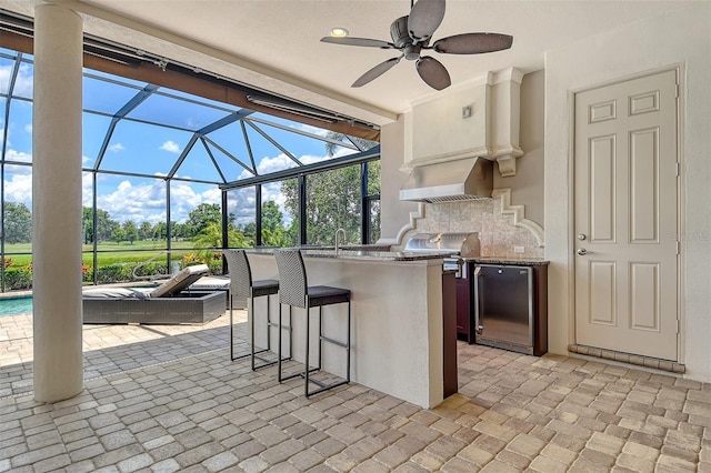 7638 Windy Hill Cv, Bradenton, FL 34202 - view of patio / terrace with an outdoor kitchen, glass enclosure, and a ceiling fan