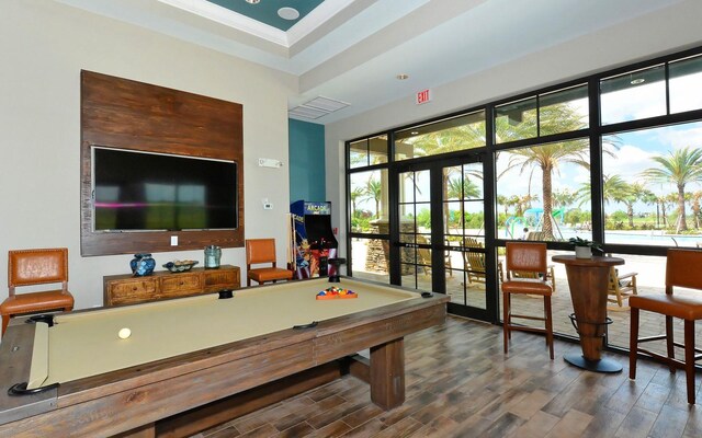 7638 Windy Hill Cv, Bradenton, FL 34202 - game room with french doors, wood finished floors, plenty of natural light, and billiards table