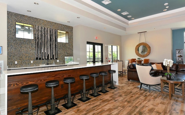 7638 Windy Hill Cv, Bradenton, FL 34202 - indoor dry bar with recessed lighting, wood finished floors, decorative backsplash, a tray ceiling, and crown molding