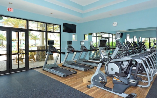 7638 Windy Hill Cv, Bradenton, FL 34202 - gym featuring french doors and wood finished floors