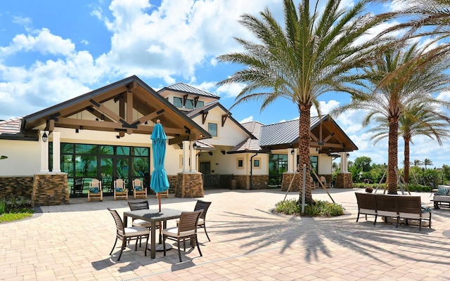 7638 Windy Hill Cv, Bradenton, FL 34202 - surrounding community with a patio area and outdoor dining area