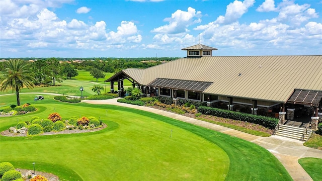 7638 Windy Hill Cv, Bradenton, FL 34202 - surrounding community with a yard, view of golf course, and a putting area
