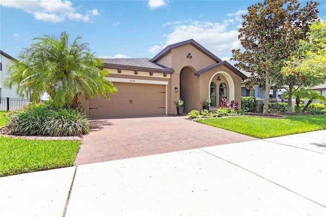 4044 Wisdom Trl, Land O Lakes, FL 34638 - mediterranean / spanish house with decorative driveway, an attached garage, and stucco siding