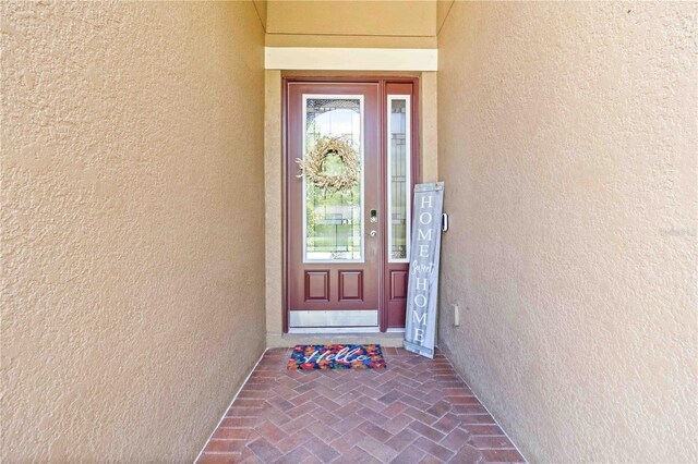 4044 Wisdom Trl, Land O Lakes, FL 34638 - doorway to property featuring stucco siding