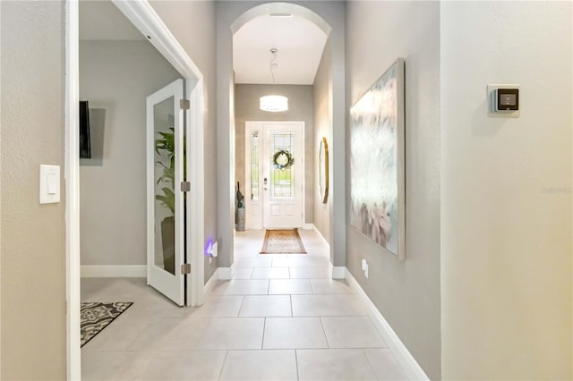 4044 Wisdom Trl, Land O Lakes, FL 34638 - doorway featuring arched walkways and light tile patterned flooring