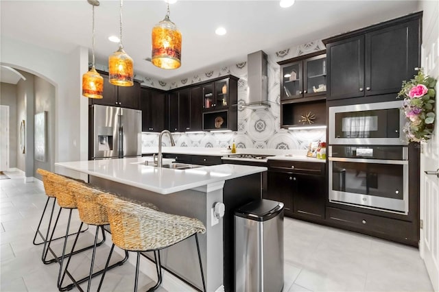4044 Wisdom Trl, Land O Lakes, FL 34638 - kitchen featuring stainless steel appliances, arched walkways, wall chimney range hood, light countertops, and recessed lighting