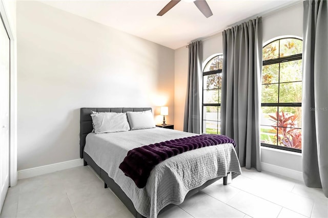 4044 Wisdom Trl, Land O Lakes, FL 34638 - bedroom with multiple windows, ceiling fan, and light tile patterned floors