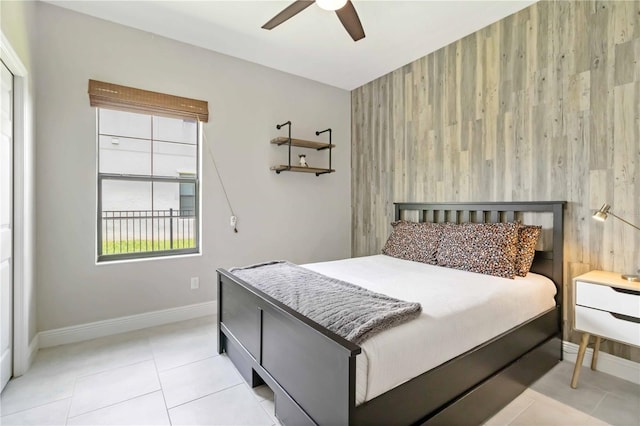 4044 Wisdom Trl, Land O Lakes, FL 34638 - bedroom with light tile patterned flooring, an accent wall, ceiling fan, and wooden walls