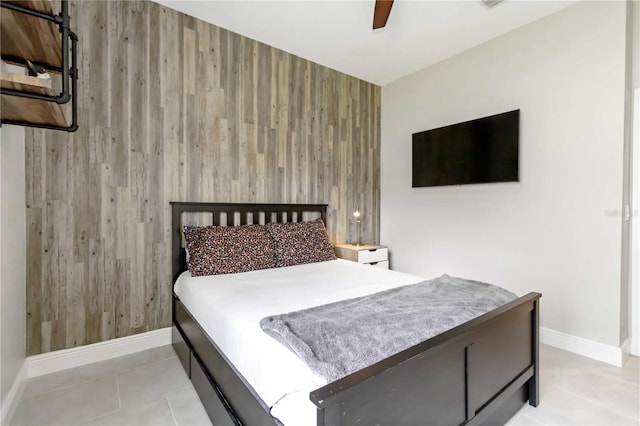4044 Wisdom Trl, Land O Lakes, FL 34638 - tiled bedroom featuring wooden walls, ceiling fan, and an accent wall
