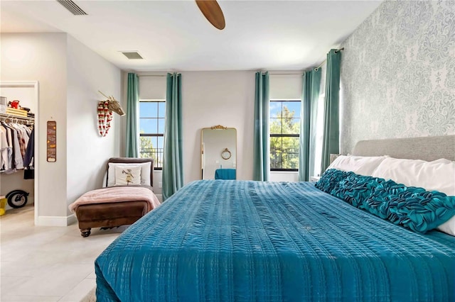 4044 Wisdom Trl, Land O Lakes, FL 34638 - bedroom with a walk in closet, a ceiling fan, and tile patterned flooring
