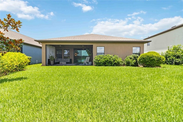 4044 Wisdom Trl, Land O Lakes, FL 34638 - rear view of property featuring a yard, stucco siding, and outdoor lounge area