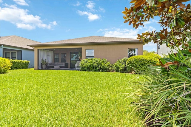 4044 Wisdom Trl, Land O Lakes, FL 34638 - rear view of property with stucco siding, a yard, a sunroom, and an outdoor hangout area