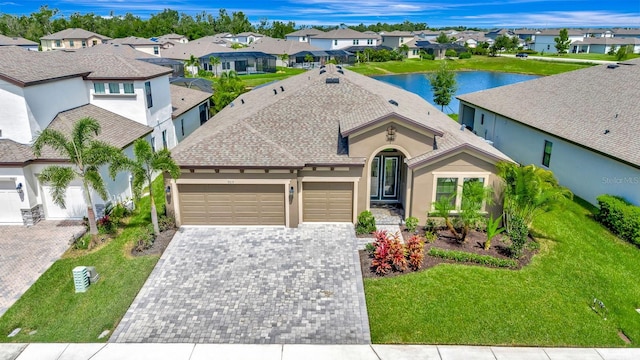 9215 Isabella Cir, Parrish, FL 34219 - view of front of house with an attached garage, a residential view, driveway, stucco siding, and a front yard