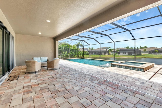 9215 Isabella Cir, Parrish, FL 34219 - view of swimming pool featuring a patio, a pool with connected hot tub, glass enclosure, a water view, and a residential view