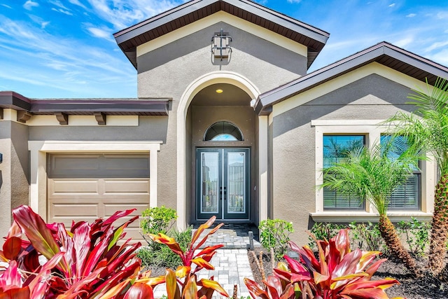 9215 Isabella Cir, Parrish, FL 34219 - entrance to property with stucco siding, french doors, and a garage