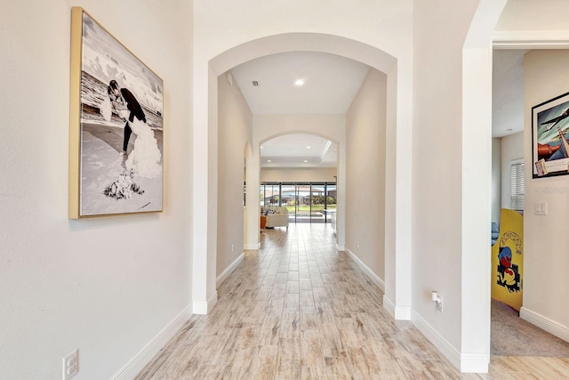 9215 Isabella Cir, Parrish, FL 34219 - corridor featuring wood finished floors, arched walkways, and recessed lighting