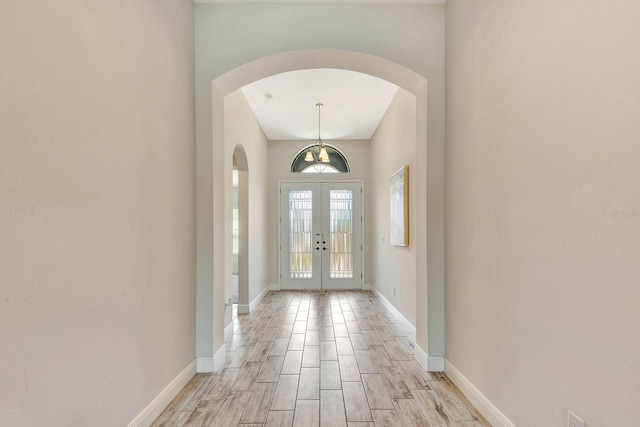 9215 Isabella Cir, Parrish, FL 34219 - foyer featuring arched walkways, french doors, and light wood finished floors