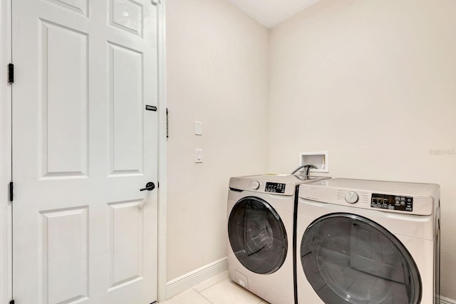 9215 Isabella Cir, Parrish, FL 34219 - washroom with washing machine and dryer and light tile patterned flooring
