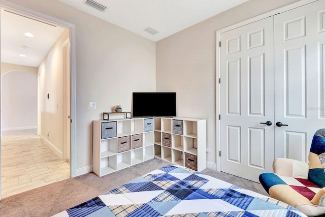 9215 Isabella Cir, Parrish, FL 34219 - bedroom featuring arched walkways, carpet floors, a closet, and recessed lighting