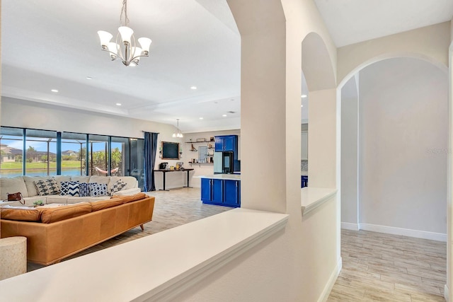 9215 Isabella Cir, Parrish, FL 34219 - living area featuring light wood-style flooring, a chandelier, recessed lighting, and arched walkways