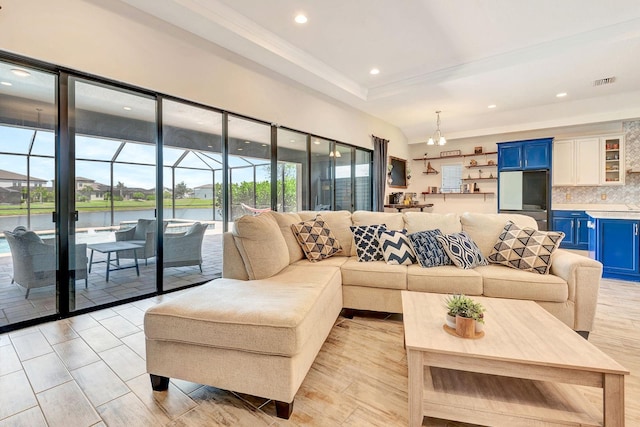 9215 Isabella Cir, Parrish, FL 34219 - living area featuring a water view, recessed lighting, a raised ceiling, and crown molding