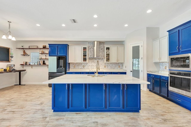 9215 Isabella Cir, Parrish, FL 34219 - kitchen with oven, wall chimney range hood, built in microwave, fridge, and blue cabinets