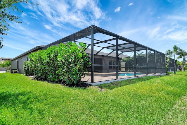 9215 Isabella Cir, Parrish, FL 34219 - rear view of property with an outdoor pool, a lawn, glass enclosure, and a patio area