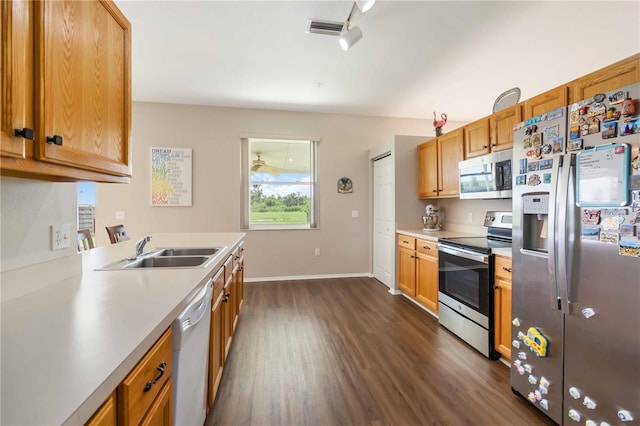 9410 71st Ave E, Palmetto, FL 34221 - kitchen featuring stainless steel appliances, dark wood-style flooring, light countertops, and brown cabinets