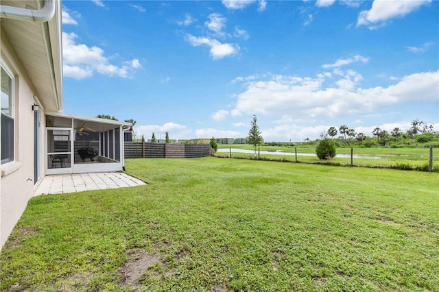 9410 71st Ave E, Palmetto, FL 34221 - view of yard featuring a sunroom, a ceiling fan, a patio, and a view of countryside
