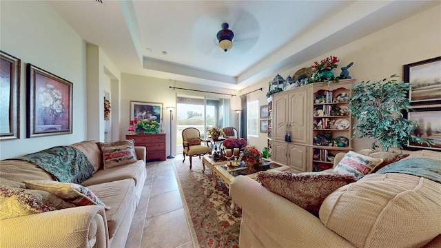2819 47th St E, Palmetto, FL 34221 - living area with a ceiling fan, a raised ceiling, and light tile patterned flooring