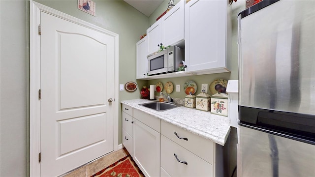 2819 47th St E, Palmetto, FL 34221 - kitchen featuring freestanding refrigerator, white microwave, and white cabinetry