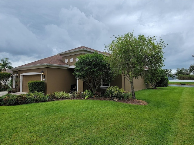 2819 47th St E, Palmetto, FL 34221 - view of front of property with stucco siding, a front lawn, and a garage