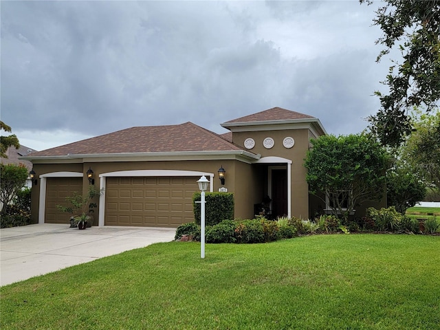 2819 47th St E, Palmetto, FL 34221 - view of front of home featuring stucco siding, a front yard, a garage, driveway, and a shingled roof