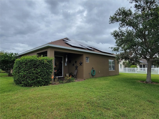 2819 47th St E, Palmetto, FL 34221 - rear view of house featuring stucco siding and solar panels