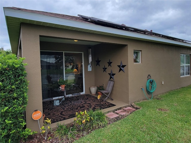 2819 47th St E, Palmetto, FL 34221 - back of house with stucco siding and a lawn