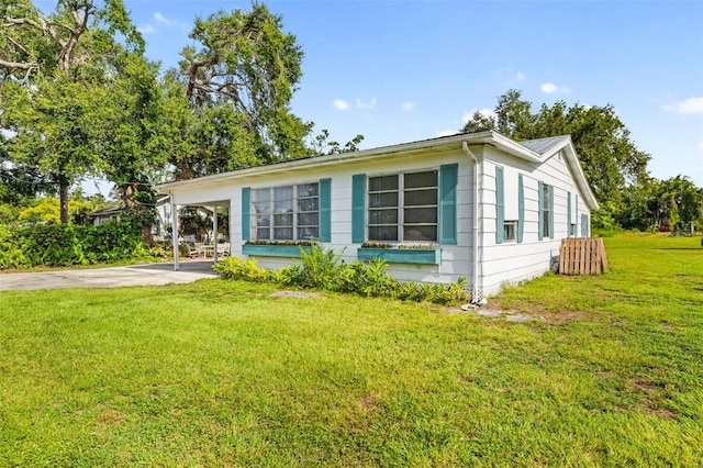 3020 51st Ave E, Bradenton, FL 34203 - view of front of home with a front lawn, concrete driveway, and a carport