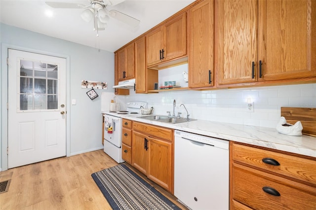 3020 51st Ave E, Bradenton, FL 34203 - kitchen featuring white appliances, under cabinet range hood, tasteful backsplash, light wood finished floors, and open shelves