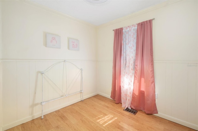 3020 51st Ave E, Bradenton, FL 34203 - unfurnished room with wood finished floors, ornamental molding, wainscoting, and a decorative wall