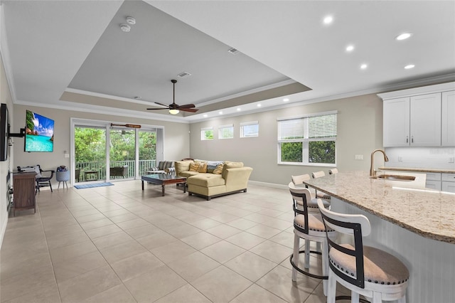 18050 Wooden Skiff Ct, Nokomis, FL 34275 - living area featuring a raised ceiling, ornamental molding, light tile patterned floors, recessed lighting, and a ceiling fan