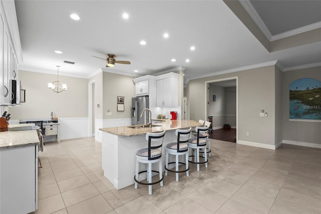 18050 Wooden Skiff Ct, Nokomis, FL 34275 - kitchen with high quality fridge, white cabinets, a ceiling fan, light stone counters, and recessed lighting