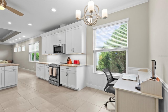18050 Wooden Skiff Ct, Nokomis, FL 34275 - kitchen with stainless steel appliances, crown molding, light countertops, wainscoting, and an office area
