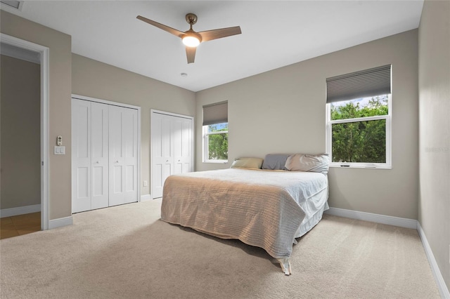 18050 Wooden Skiff Ct, Nokomis, FL 34275 - bedroom featuring two closets, carpet, and a ceiling fan
