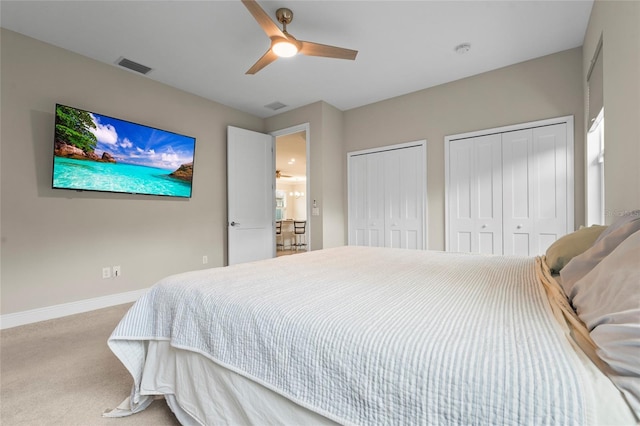 18050 Wooden Skiff Ct, Nokomis, FL 34275 - carpeted bedroom featuring two closets and a ceiling fan