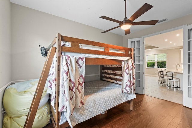 18050 Wooden Skiff Ct, Nokomis, FL 34275 - bedroom with french doors and hardwood / wood-style floors