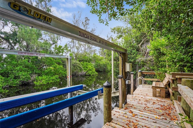 18050 Wooden Skiff Ct, Nokomis, FL 34275 - dock featuring a water view and view of wooded area