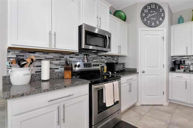 5134 Jackel Chase Dr, Wimauma, FL 33598 - kitchen featuring stainless steel appliances, backsplash, white cabinets, and dark stone countertops
